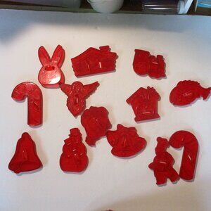 13 vintage red plastic 1950's  cookie cutters, mostly Christmas